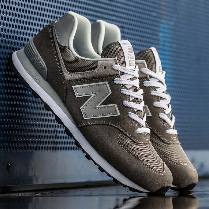Classic grey 574s propped against blue metal wall